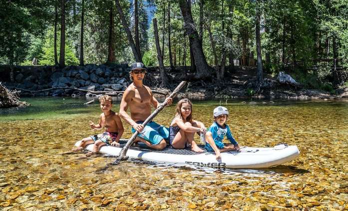 A family paddling in the clear waters at Yosemite national park