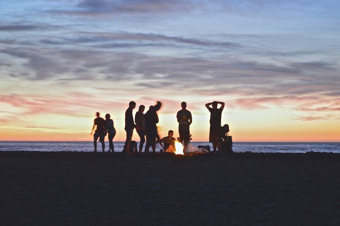 A group of hikers bonding around a campfire