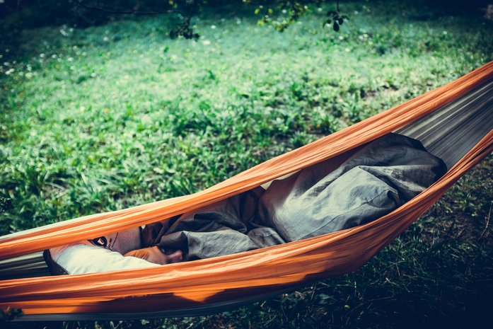 A camper enjoying some sleep on the hammock
