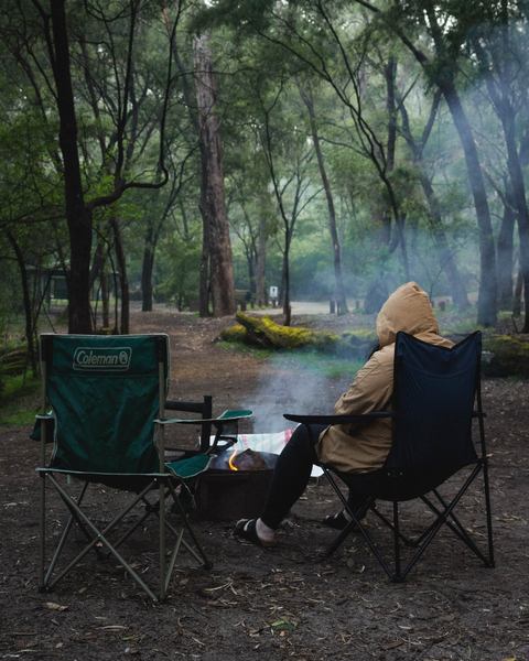 A camper relaxing on a comfortable camping chair